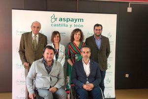 Representantes de ASPAYM y del PSOE posan a la entrada del centro